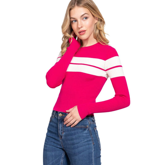 Stylish model posing with her hand on her hip, wearing a pink crew neck sweater featuring white stripes.