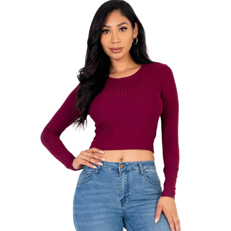 Load image into Gallery viewer, Woman in a maroon ribbed long-sleeve crop top posing confidently, pairing it with casual blue jeans for a trendy look.
