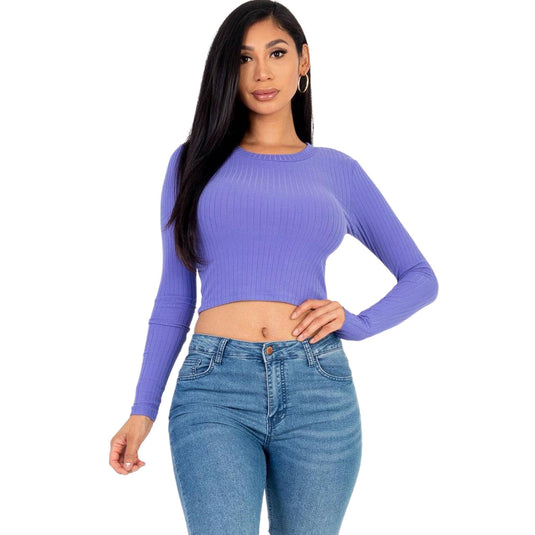 Fashionable woman wearing a lilac ribbed long-sleeve crop top, adding a splash of soft color to a classic streetwear outfit.