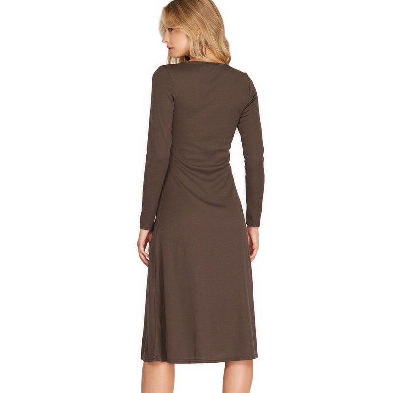 Load image into Gallery viewer, Back view of a rich brown long sleeve midi dress with a soft knit composition, highlighting a simple, sleek design with a flowing skirt portion.
