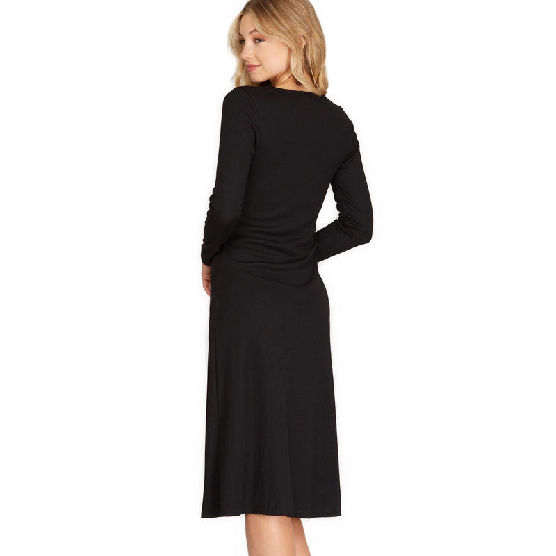 Load image into Gallery viewer, Back view of a classic black long sleeve midi dress with a seamless knit design, showcasing a subtle flare at the hem for a graceful, timeless look.
