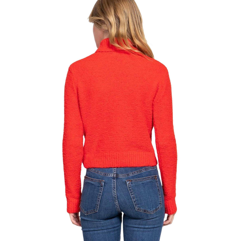 Load image into Gallery viewer, Back view of a woman in a red fluffy turtleneck sweater, highlighting the fit on blue jeans.
