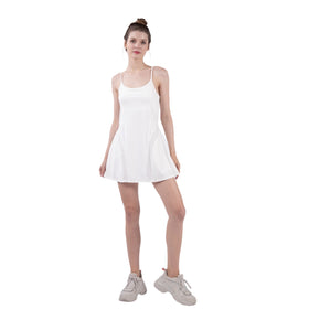 Woman posing in a white Mesh Detail Active Tennis Mini Dress with built-in shorts, highlighting the dress's sporty and chic look. Perfect for various activities.