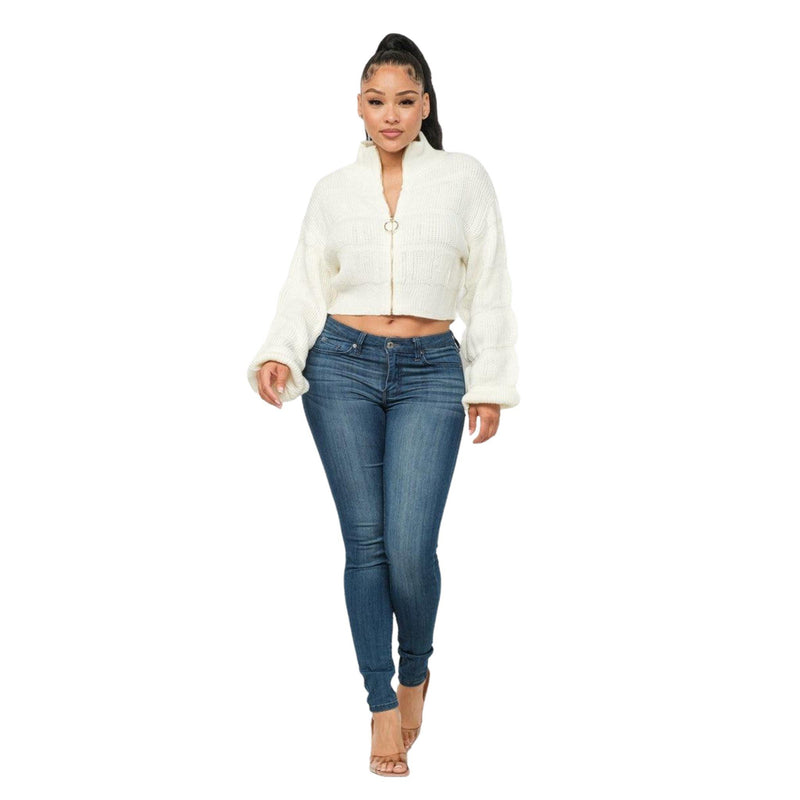 Load image into Gallery viewer, rontal view of a model in a white zip-up knitted sweater and high-waisted denim, creating a chic and modern look.
