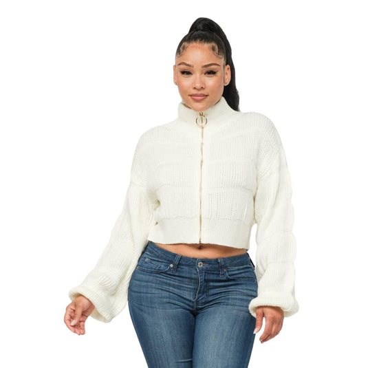 Casual yet stylish white ribbed sweater with a distinctive front zipper, complemented by snug blue denim jeans.
