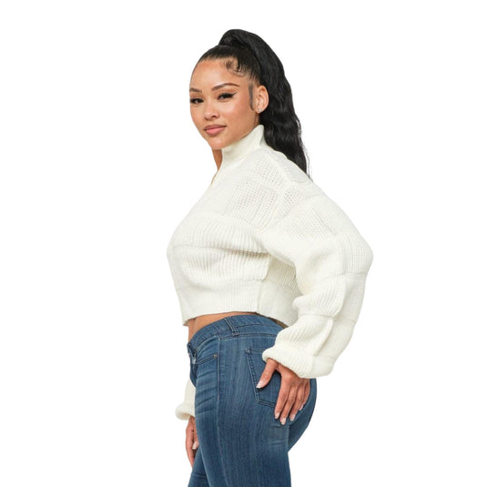 Side view of a model wearing a textured white cropped sweater with an exposed zipper, perfect for a relaxed yet polished look.