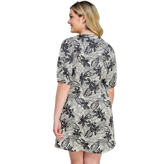 Back perspective of a stylish black and white botanical print dress, capturing the relaxed elegance.