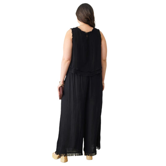 Rear view of a bohemian-style sleeveless black top with unique frayed detailing, exemplifying relaxed elegance.