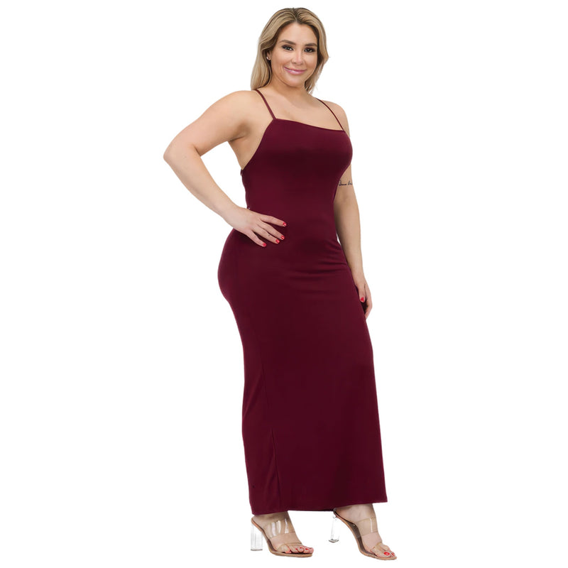 Load image into Gallery viewer, Side view of a woman wearing a deep burgundy plus size maxi dress with a thigh slit, showcasing the dress&#39;s contouring fit and elongated silhouette.
