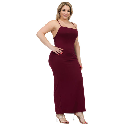 Side view of a woman wearing a deep burgundy plus size maxi dress with a thigh slit, showcasing the dress's contouring fit and elongated silhouette.
