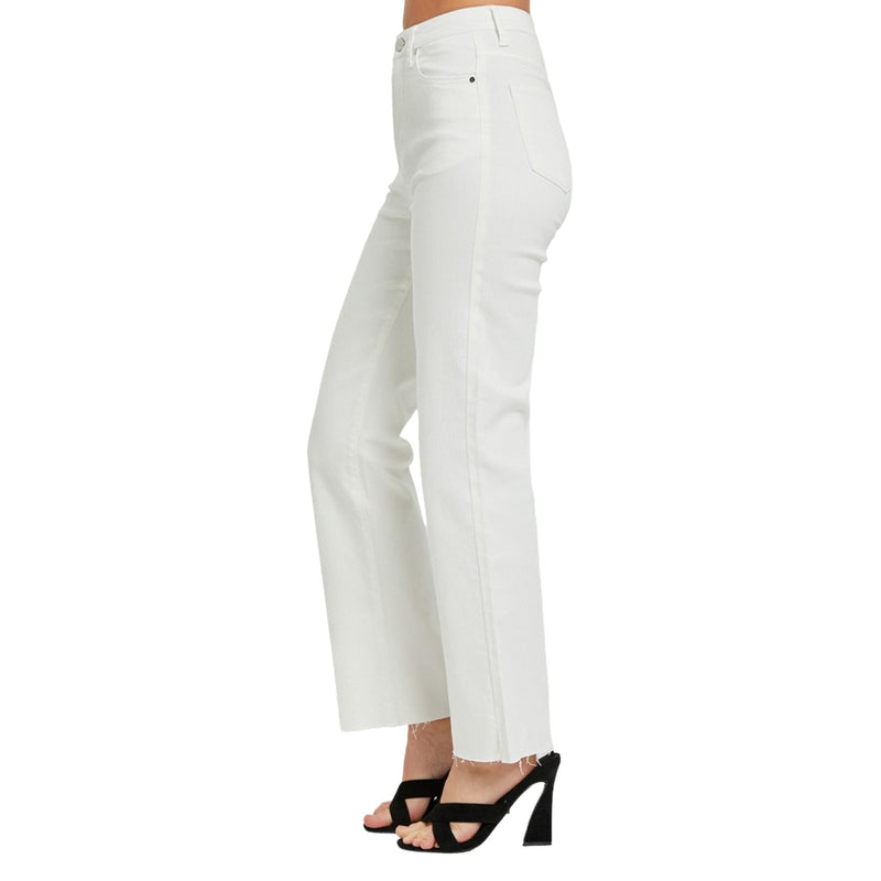 Load image into Gallery viewer, Side view of high-rise white straight-leg jeans, showcasing the clean lines and raw hem detail, paired with black heels.
