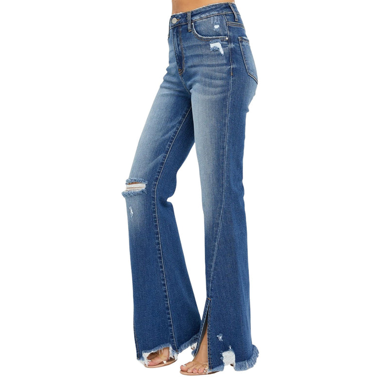 Load image into Gallery viewer, Side view of plus-size high-rise flare jeans featuring a front slit and frayed hem. The distressed details add a touch of edgy style, while the flare cut offers a retro, flattering fit.
