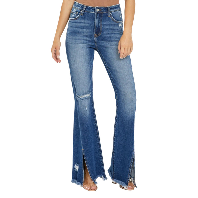 Load image into Gallery viewer, Front view close-up of plus-size high-rise flare jeans with a front slit and frayed hem. The jeans&#39; distressed details and stylish flare create a modern yet retro look.
