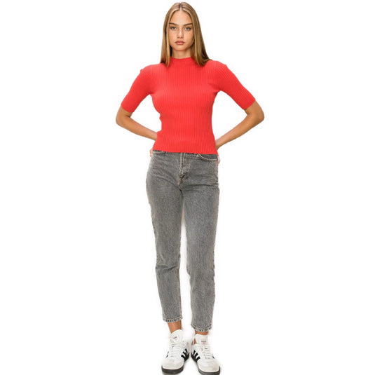 Fashion-forward red mock neck ribbed sweater worn with relaxed-fit grey jeans and white sneakers for a casual-chic vibe.