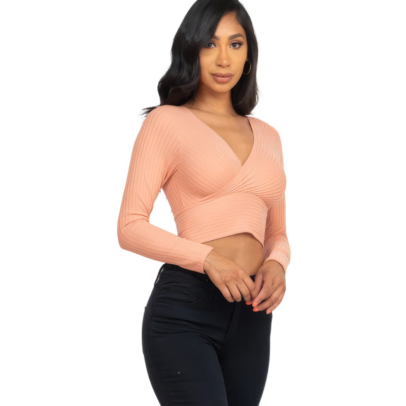 Load image into Gallery viewer, Fashion-forward woman in a Peach Ribbed Wrap Front Long Sleeve Top, featuring a crisscross front and sleek V-neckline.
