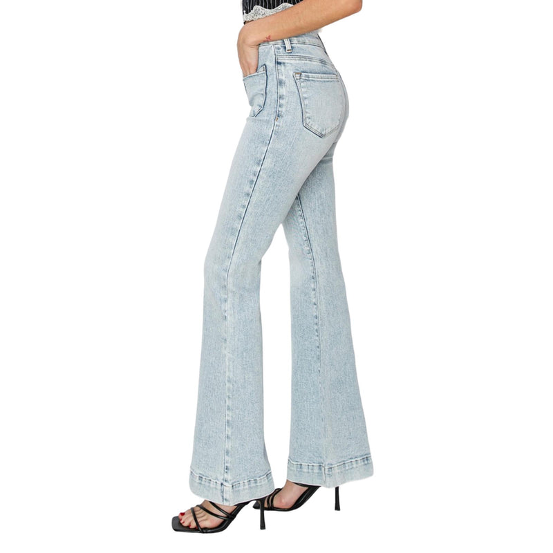 Load image into Gallery viewer, Model displaying the side view of the jeans with front patch pockets and fitted silhouette.
