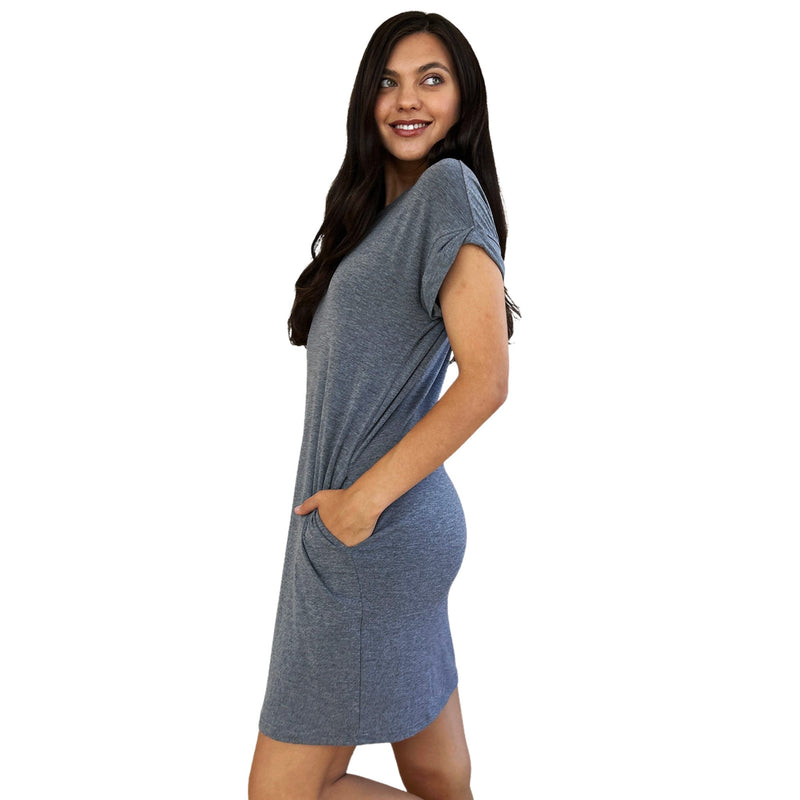 Load image into Gallery viewer, Brunette woman smiling and posing in a blue-grey short-sleeve dress with pockets, showcasing a casual and comfortable style perfect for everyday wear.
