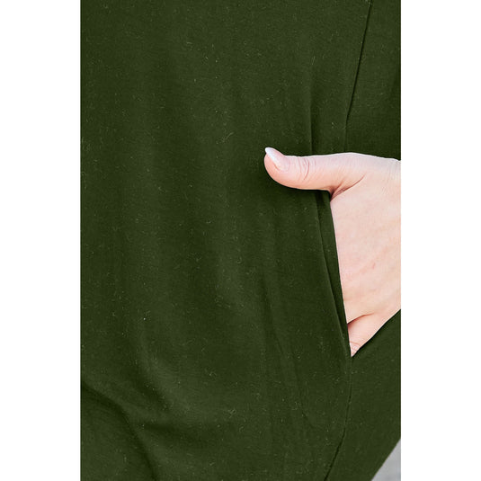 Close-up of a woman's hand resting in the pocket of a green casual dress made from bamboo and spandex blend, highlighting the practical and comfortable design