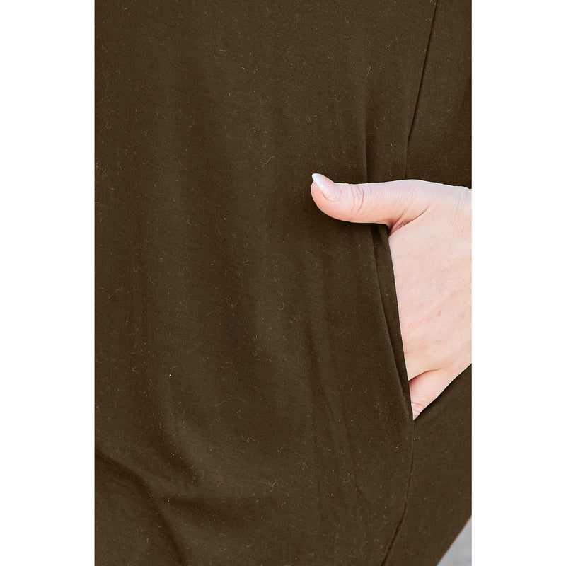 Load image into Gallery viewer, Close-up of a woman&#39;s hand resting in the pocket of a brown casual dress made from bamboo and spandex blend, highlighting the practical and comfortable design.
