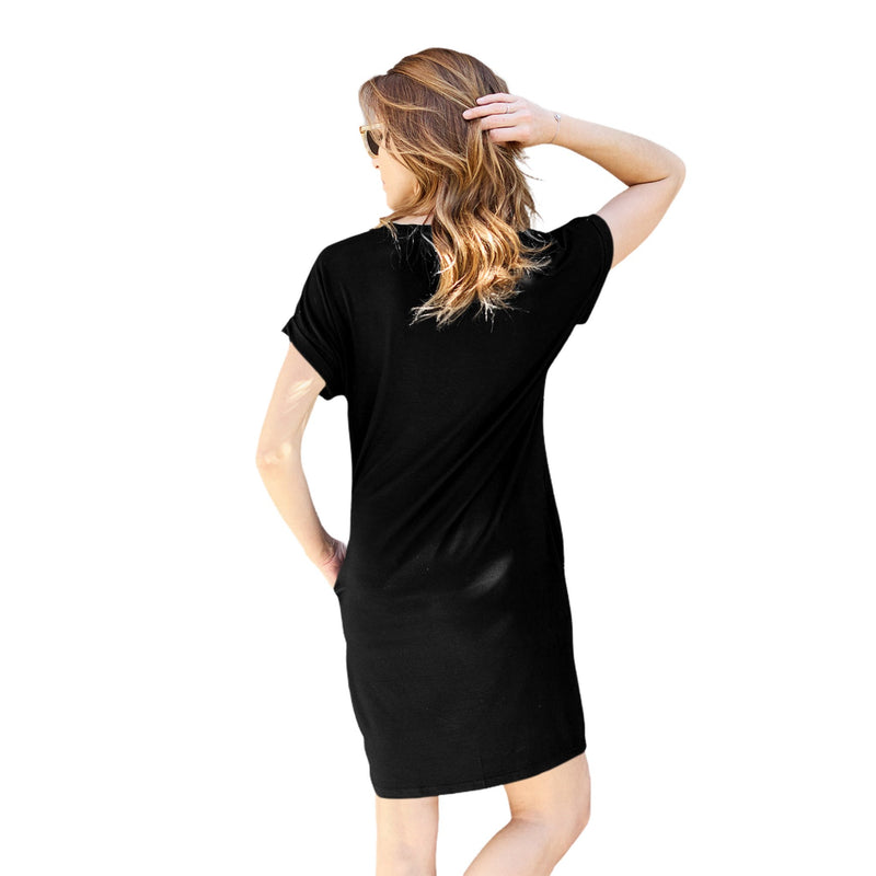 Load image into Gallery viewer, Woman wearing a black casual dress with a round neck and short sleeves, facing away, styled with sunglasses and long wavy hair.
