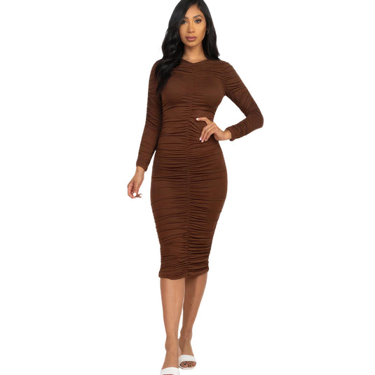 Fashionable woman presenting a coffee-colored ruched long sleeve midi dress that highlights a flattering body silhouette.