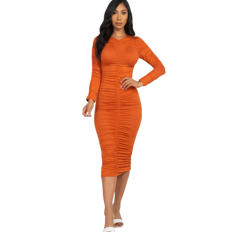 Load image into Gallery viewer, Striking tomato cream colored ruched midi dress with long sleeves, offering a vibrant and body-flattering fit on a model.
