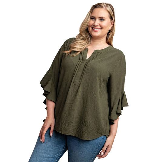 Cheerful plus-size woman wearing an olive green ruffled bell sleeve top with a front pleat detail, perfect for a sophisticated look.
