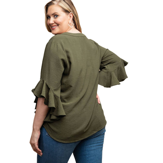 Back view of a woman in an olive green ruffled bell sleeve blouse, highlighting the elegant flow and design suitable for plus-size.