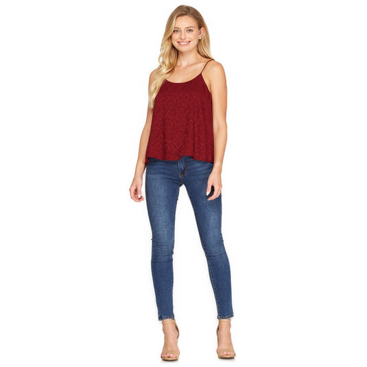 Full body view of a woman wearing a rich wine-colored satin camisole top with an elegant jacquard design, paired with fitted jeans, perfect for a chic day-to-night ensemble.