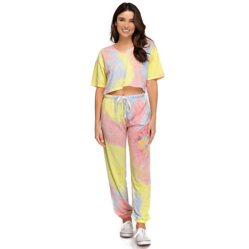 Load image into Gallery viewer, Full outfit featuring a woman in a yellow/pink tie-dye Short Sleeve V Neck Terry Crop Top with matching tie-dye drawstring pants, offering a cohesive, casual summer look. Available in sizes S, M, L.

