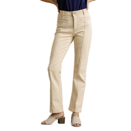 Front view of natural-colored straight-cut denim pants paired with a navy blue top and textured heels, showcasing a classic fit.