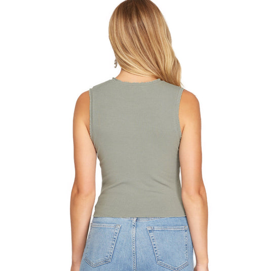 Rear view of a woman in a gray sleeveless rib knit top with ruffled trim, showcasing the simple yet elegant back design that complements the casual chic look.