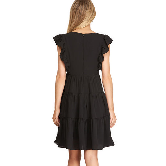 A sophisticated back view of a sleeveless black summer dress with tiered ruffles, a staple for any elegant evening.