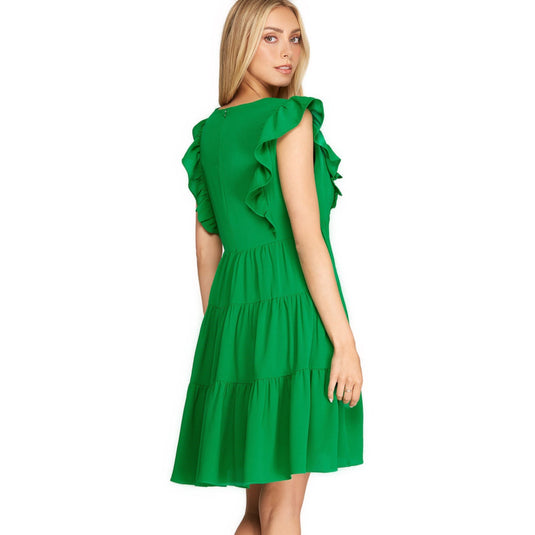  A fresh look from behind of a sleeveless, emerald green dress with layered ruffles, embodying effortless style for the season.