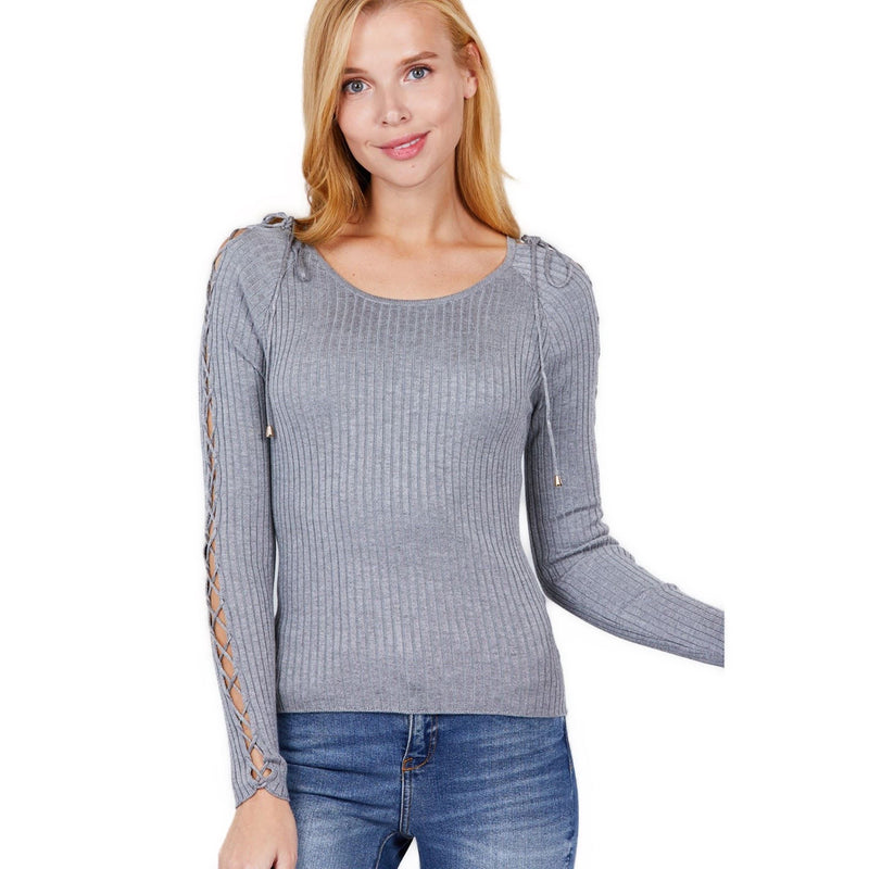 Load image into Gallery viewer, A woman models a heather grey ribbed sweater with unique strappy shoulder details. She stands against a white background, giving the camera a soft, inviting look.
