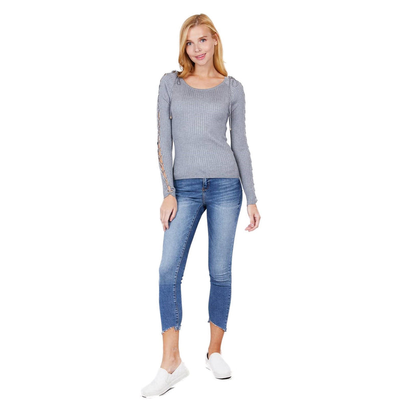 Load image into Gallery viewer, Full-length view of a woman wearing a heather grey ribbed sweater and blue denim jeans, complemented by white slip-on shoes, against a white backdrop.
