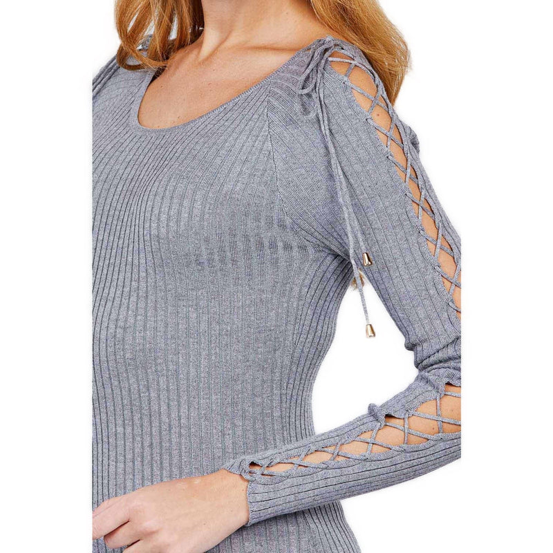 Load image into Gallery viewer, Side angle view highlighting the strappy shoulder design of a heather grey ribbed sweater on a woman, with a focus on the sleeve and ribbed texture.&quot;
