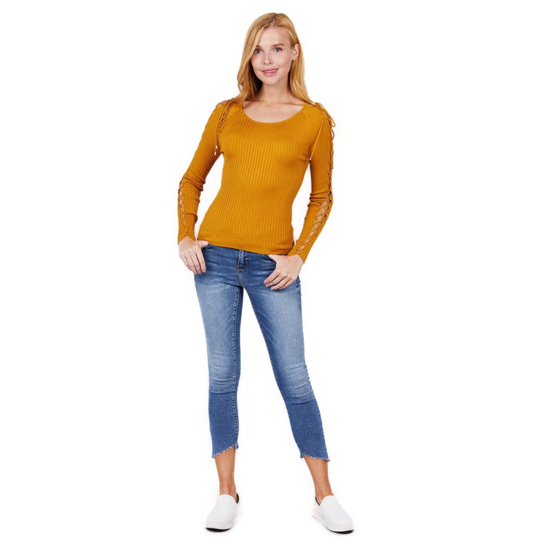 Load image into Gallery viewer, A woman stands confidently in a mustard ribbed sweater with strappy sleeves, paired with blue cropped jeans and white sneakers.
