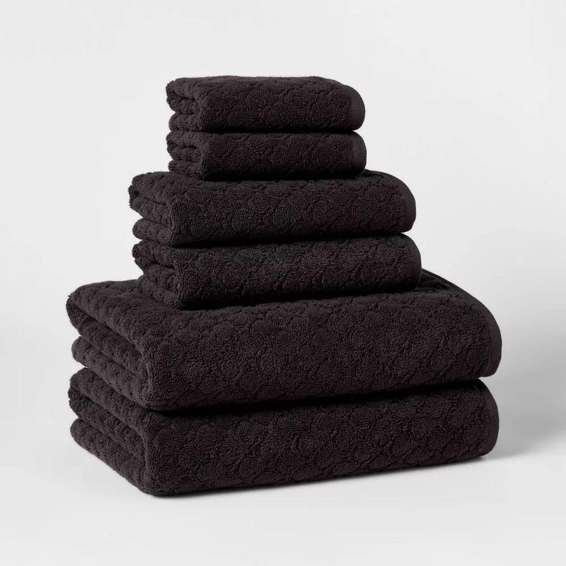 Load image into Gallery viewer, A neatly stacked set of six luxurious black bath towels made from 100% cotton, showcasing the ultra-soft texture that enhances your bathing experience.
