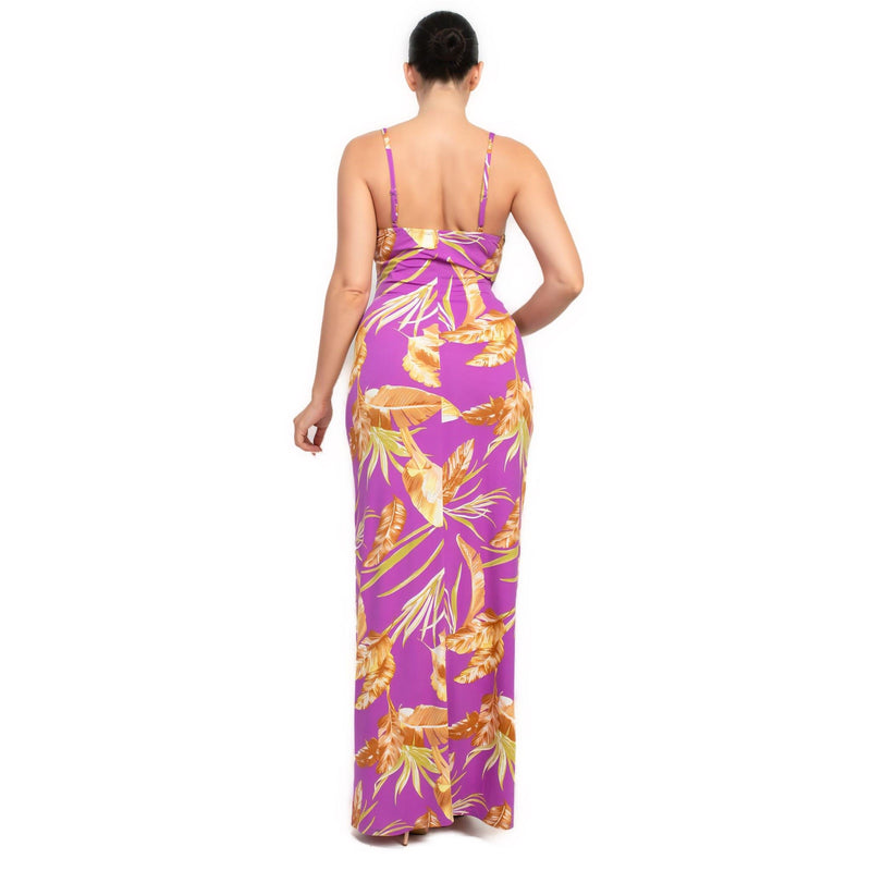 Load image into Gallery viewer, Rear view of a purple bodycon maxi dress with a lush tropical print, showing the dress&#39;s sleek and chic style.
