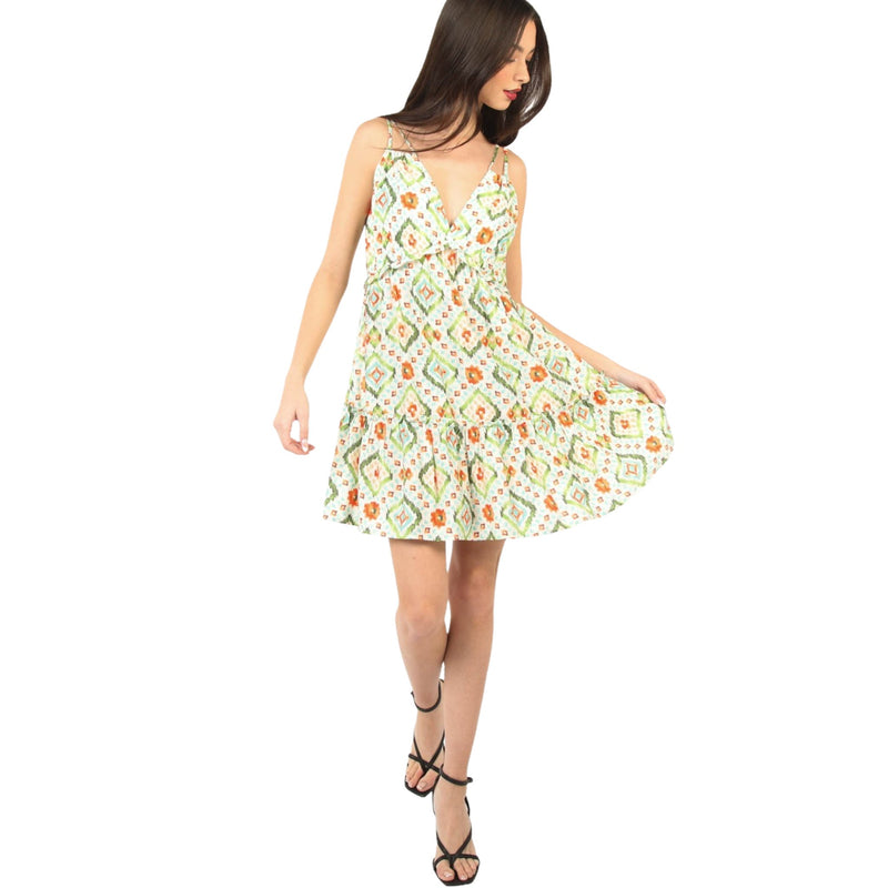 Load image into Gallery viewer, Woman twirling in a Tunnel Detail Multi Color Printed Mini Dress, showing the vibrant pattern and ruffled design. The dress has a deep V-neckline, adjustable spaghetti straps, and a smocked back for a perfect fit.
