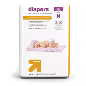 White newborn diaper package for up to 10 lbs from Up & Up with purple accents showing a sleeping baby on the front, highlighting SuperAbsorb channels for premium dryness and comfort.