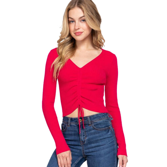 Fuchsia V-neck sweater with a shirring and tie-up detail at the front, presented by a model to highlight the vibrant color and stylish fit.