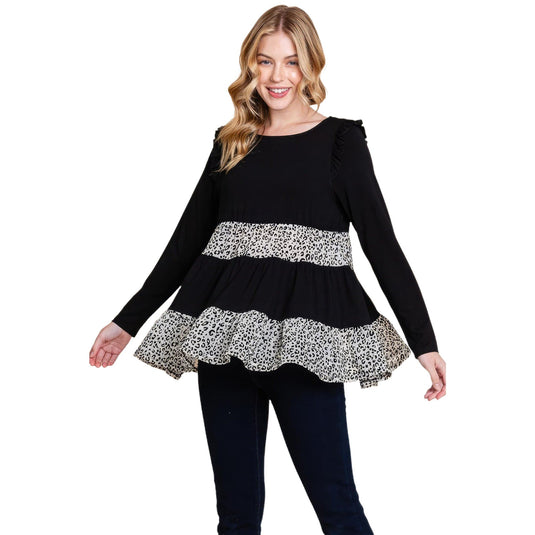 Smiling model presents a black velvet animal print tiered top, highlighting the playful ruffles and elegant print contrast.