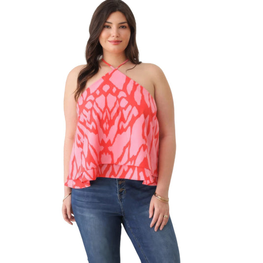 Plus size model wearing a vibrant red and pink abstract print halter top with a flouncy ruffle hem.