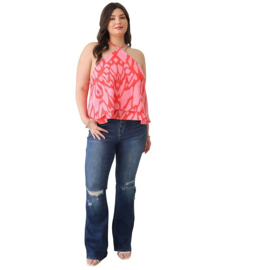 Full-body shot of a stylish sleeveless halter neck top in an abstract print, paired with blue jeans.
