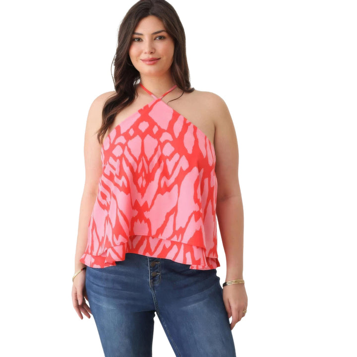 Close-up view of a plus size halter top with a red and pink abstract pattern, showcasing the neck tie detail.