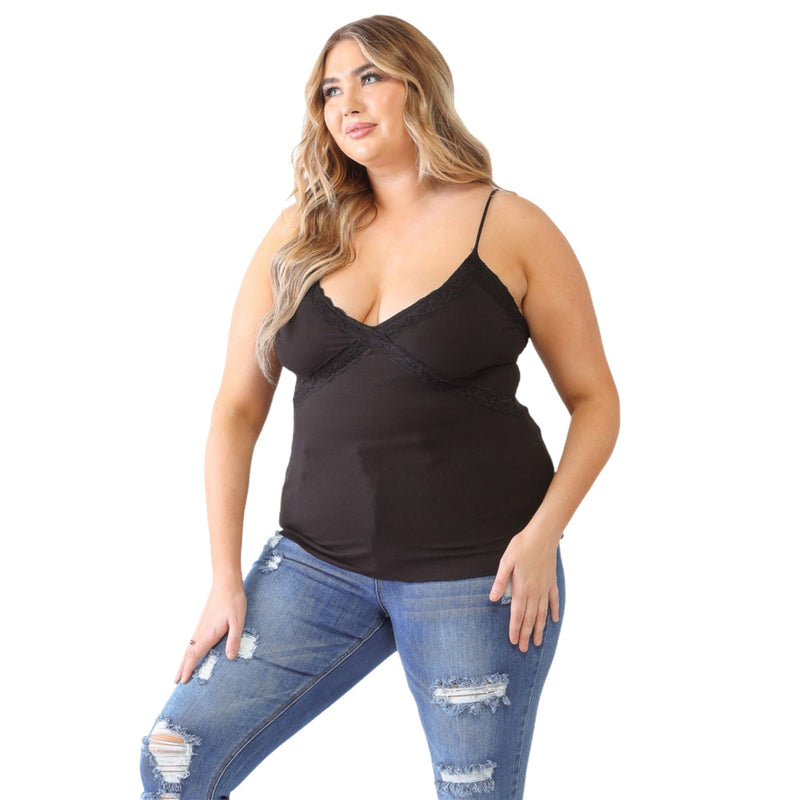 Load image into Gallery viewer, Plus-size model wearing a black lace V-neck cami paired with distressed blue jeans, facing forward with a confident pose.
