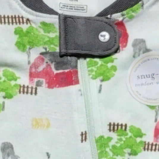Close-up of the neckline of boys' barnyard print pajama, highlighting the snap tab zipper cover and the soft, organic cotton texture.