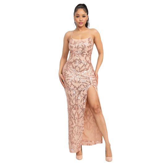 Model angled to the side, highlighting the side profile and thigh slit of a champagne sequin maxi dress with delicate crisscross tie-back detail.